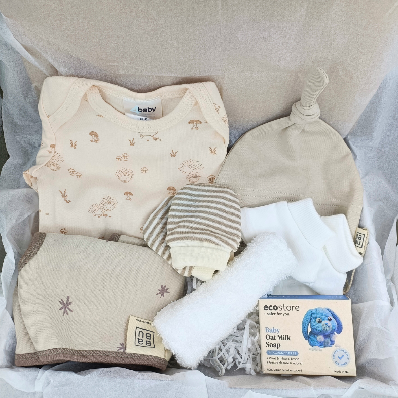 Newborn gift box NZ with baby essentials including onesie, hat, bib and booties